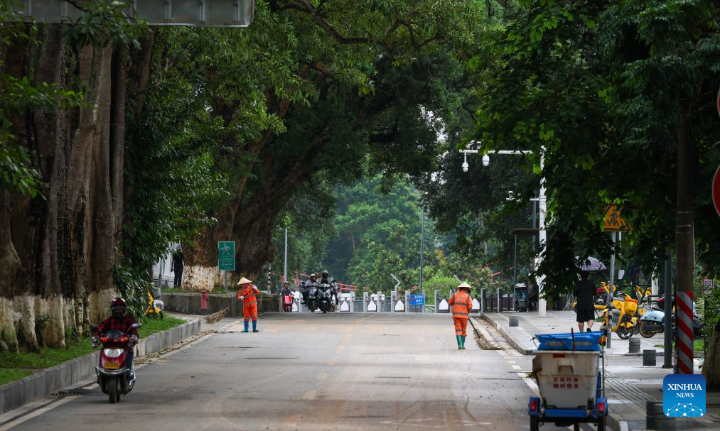 Sanitation workers clear a road in Wuzhishan City, south China's Hainan Province, Sept. 15, 2026. As the intensity and extent of torrential rainfall decreased, Hainan has shifted to full-scale post-disaster recovery operations across the province. (Xinhua/Yang Guanyu)