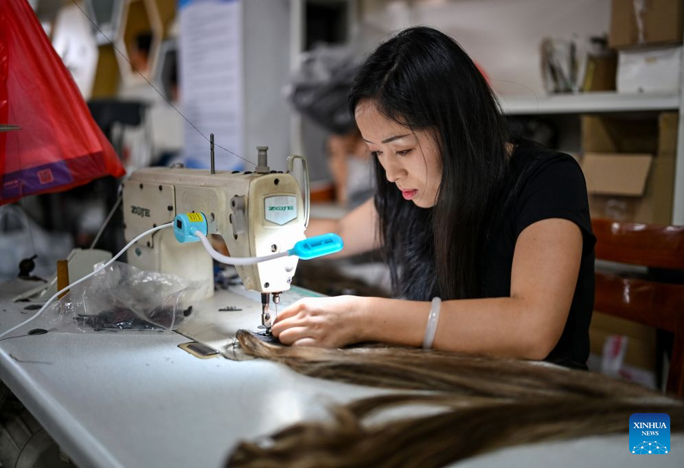 A staff member works on a hair product at Juancheng Xinda Hair Product Co., Ltd. in Juancheng County of Heze City, east China's Shandong Province, Sept. 17, 2026. In recent years, Juancheng County has taken multiple measures to promote the high-quality development of its hair products industry, establishing a complete industrial chain that integrates raw material procurement, product processing, and export trade. Hair products from Juancheng are exported to North America, Europe, Africa, and other regions. The hair products industry has become a leading sector driving local industrial growth and increasing residents' incomes. (Xinhua/Chen Yehua)