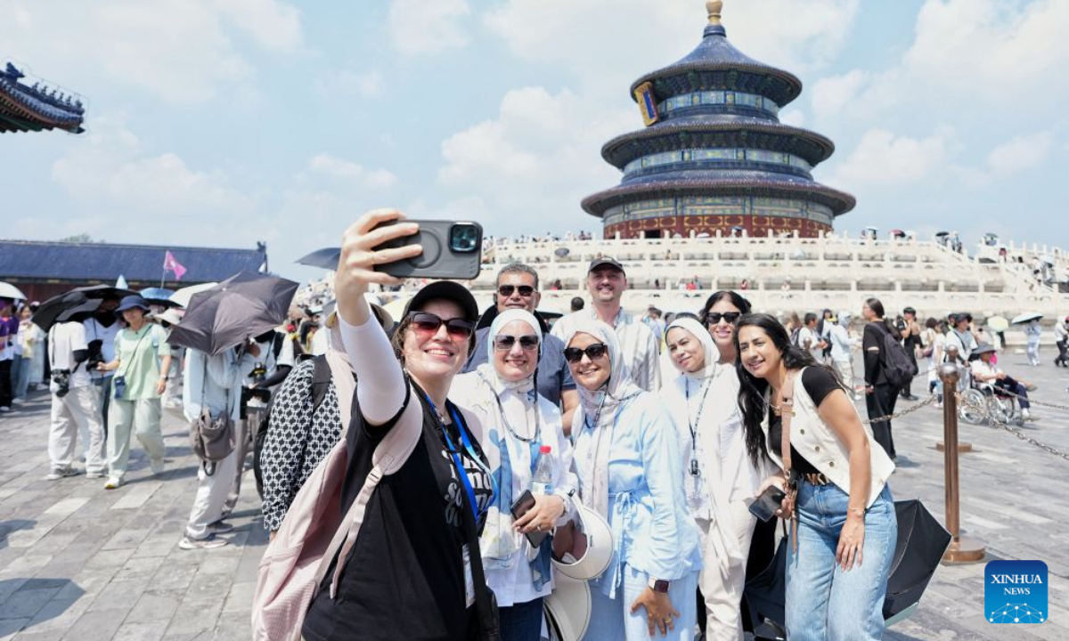 Tourists from Egypt take selfies in front of the Hall of Prayer for Good Harvests at the Temple of Heaven Park in Beijing, capital of China, July 28, 2026. Thanks to the visa-free entry policies, China has witnessed an increasing number of foreign tourists visiting China this summer. According to the official data, 77.7 percent of foreign visitors entering China in the first half of the year enjoyed visa-free entry policies. (Xinhua/Ju Huanzong)