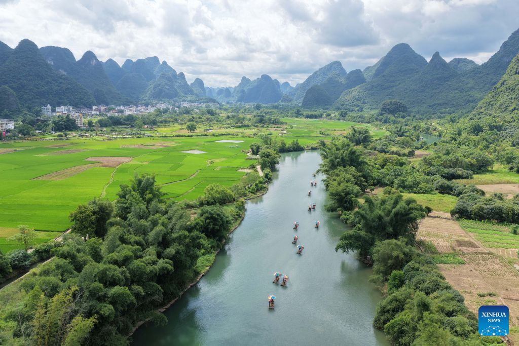 An aerial drone photo taken on Aug. 2, 2026 shows tourists enjoying scenery by rafts on Yulong river in Yangshuo County of Guilin City, south China's Guangxi Zhuang Autonomous Region. (Photo by Jiang Keqing/Xinhua)