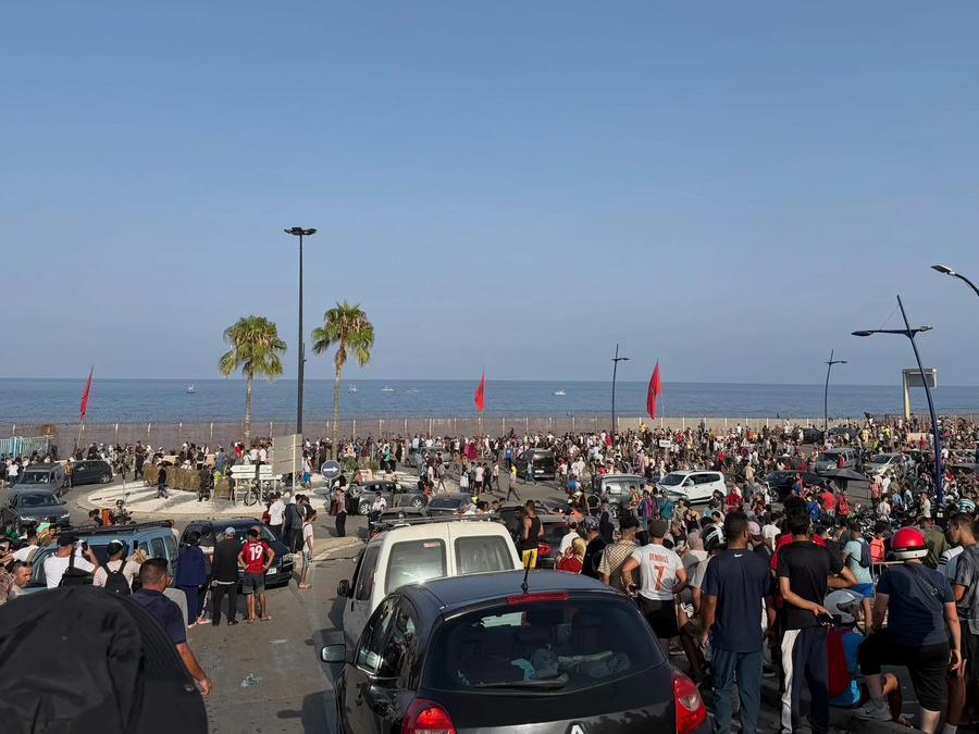 People gather on the Moroccan side of the border with Spain's North African enclave of Ceuta, preparing to cross into the enclave, on July 30, 2026.  (Photo by Liu Wenyong/Xinhua)