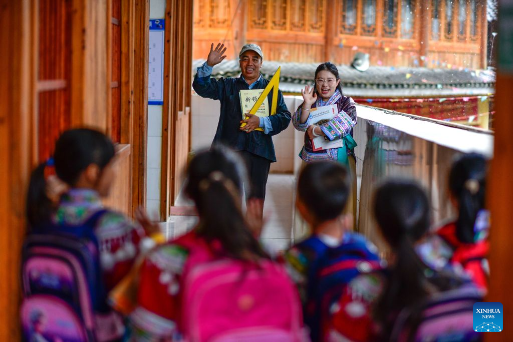 Pan Xianfeng (L, back) and Peng Hanping (R, back) wave goodbye to students after school at the Wuying teaching site in Wuying Village on the border between south China's Guangxi Zhuang Autonomous Region and southwest China's Guizhou Province, Sept. 4, 2026. Deep in the mountains on the border between south China's Guangxi Zhuang Autonomous Region and southwest China's Guizhou Province, Wuying Village is far from the township central school. To solve the problem of children having to travel long distances to school, the Wuying teaching site has been retained to this day. This semester it has only two teachers, 56-year-old Pan Xianfeng from Guizhou and 29-year-old Peng Hanping from Guangxi, and 10 students, making it a micro-primary school.
Due to its remote location and harsh conditions, few teachers are willing to teach here for long. Pan applied to transfer here in March 2020 from a better-equipped rural school in Guizhou and Peng followed in September 2023 from a Guangxi primary school. The two, from different provinces and belong to different generations, work in close coordination to keep the school running.
Beyond the classroom, they have volunteered at the village night school, teaching local residents literacy and Mandarin, broadening their perspectives and paving way for better livelihoods.
Even with only one student, the teaching site must continue, Pan said firmly. Peng added, It is all worthwhile so long as the children can go to school nearby, no matter how difficult the work gets. (Xinhua/Yang Wenbin)