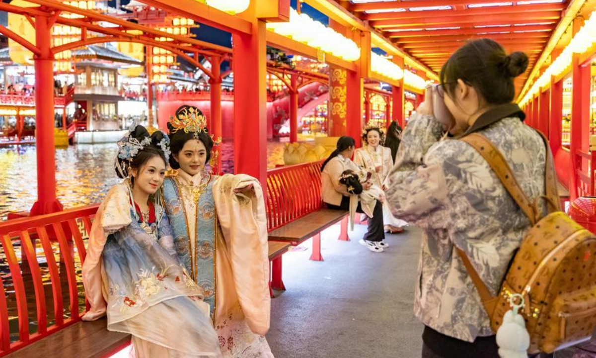 Tourists pose for a photo at the Hetou Old Street scenic area in Fengnan District of Tangshan City, north China's Hebei Province, Oct. 3, 2026. (Photo by Li Xiuqing/Xinhua)