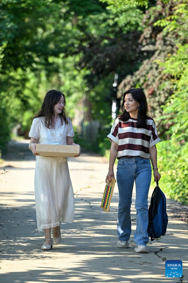 Tao Suling (L) and Chen Hong, teachers of Jinhu Special Education School, prepare to pay a home visit to a student in Jinhu County of Huai'an, east China's Jiangsu Province, May 29, 2026. (Photo by Liang Debin/Xinhua)