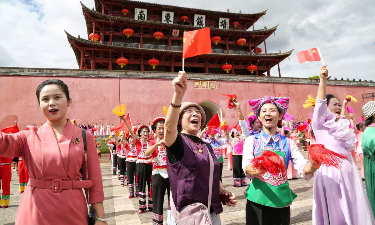 Tourists and performers sing Ode to the Motherland during a National Day event in Jianshui Ancient City, Southwest China’s Yunnan Province, on October 1, 2026.