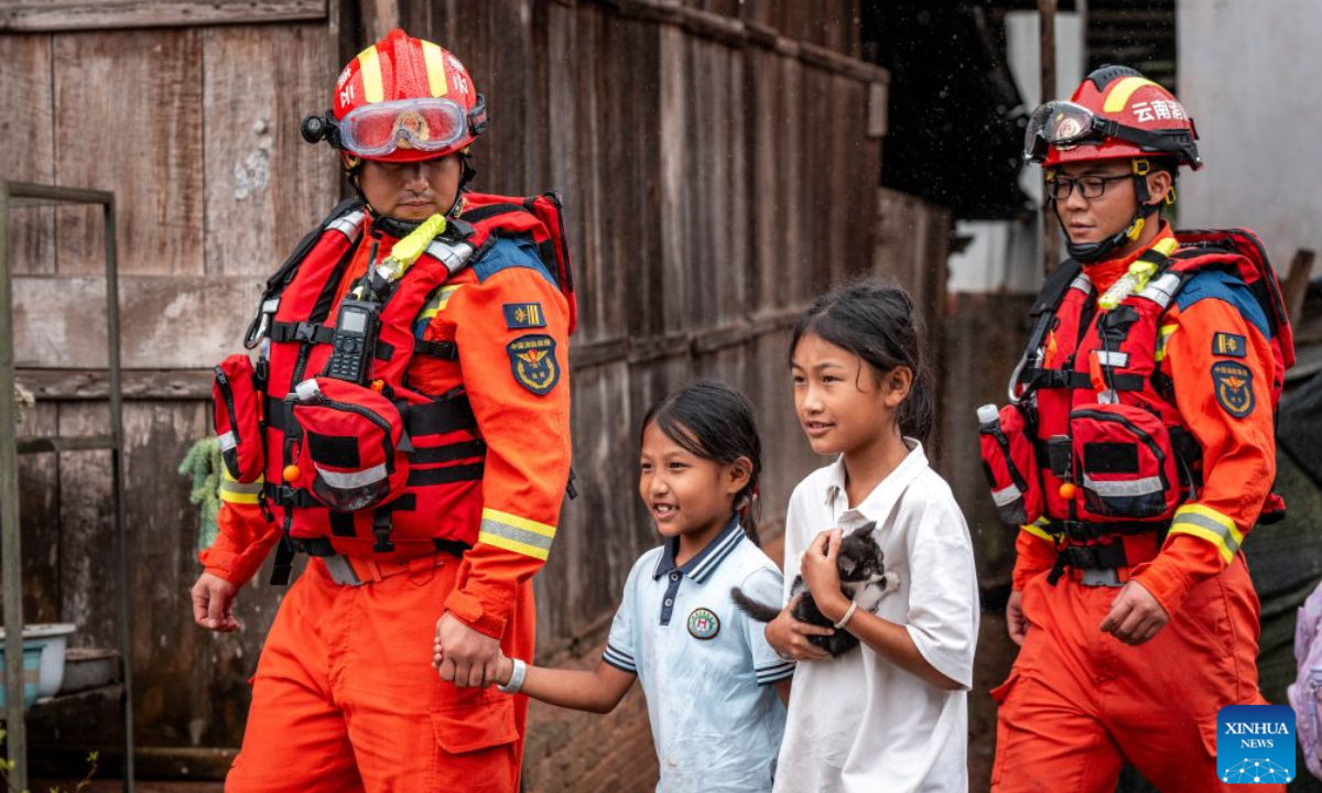 Children are evacuated by firefighters to a temporary shelter in Molong Village of Mohan Town, southwest China's Yunnan Province, Aug. 30, 2026.
Heavy rainfall has triggered severe flooding in Mohan Town in southwest China's Yunnan Province, with a reservoir at risk of breaching, authorities said Saturday.
Altogether 8,115 residents have been evacuated in emergency by Sunday, and relief items are dispatched to relocations sites to meet people's necessities. (Xinhua/Hu Chao)