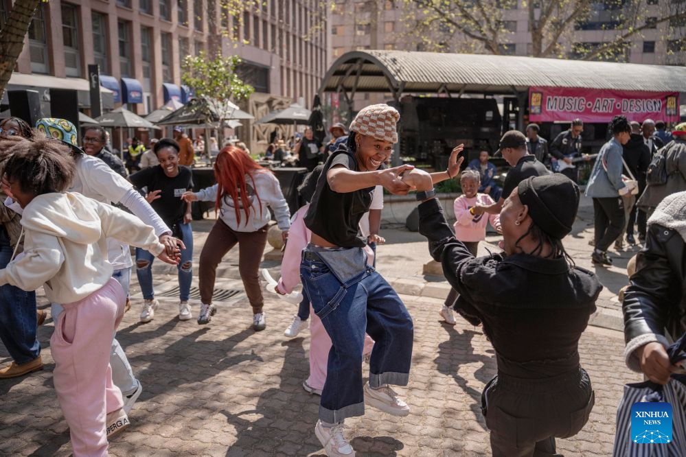 People dance on a street during a car-free event in Johannesburg, South Africa, Aug. 9, 2026. During the event, some streets in Johannesburg were turned into car-free zones from 10 a.m. to 5 p.m., with motor vehicles banned. (Photo by Ihsaan Haffejee/Xinhua)