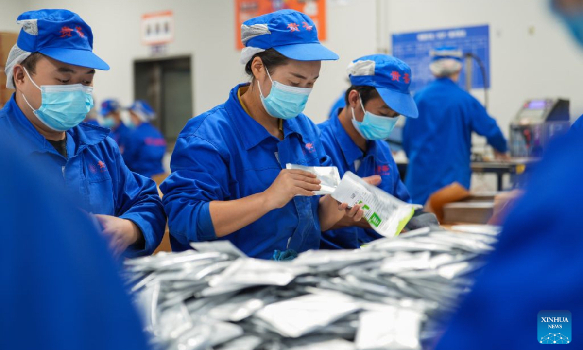 This file photo taken on Sept. 14, 2025 shows workers packaging matcha products at a workshop of Gui Tea Group in Jiangkou County, Tongren City, southwest China's Guizhou Province. (Photo by Shen Yikai/Xinhua)