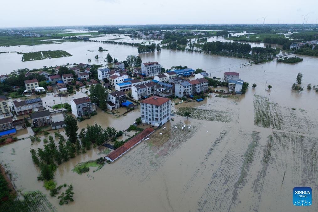 An aerial drone photo taken on Aug. 12, 2026 shows a view of Nanwang Village of Xiangzhou District, Xiangyang City of central China's Hubei Province. Torrential rains and flooding caused by Typhoon Dolphin, the 13th typhoon of the year, have swept vast regions in eastern and central China. Local authorities are exerting all efforts to eradicate potential risks and put people's life back to normal. (Xinhua/Wu Zhizun)