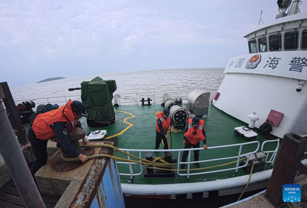 Law enforcers from China Coast Guard tie the vessel upon their arrival at the Dajinshan island in Shanghai, east China, Sept. 18, 2026. Dajinshan island boasts an excellent natural environment. To better secure the biodiversity and the ecology on the island, members of the local coast guard regularly patrol here to check the growth of native vegetation, watch out for possible invasion of alien species, and monitor the water quality in the surrounding sea area. (Xinhua/Fang Zhe)