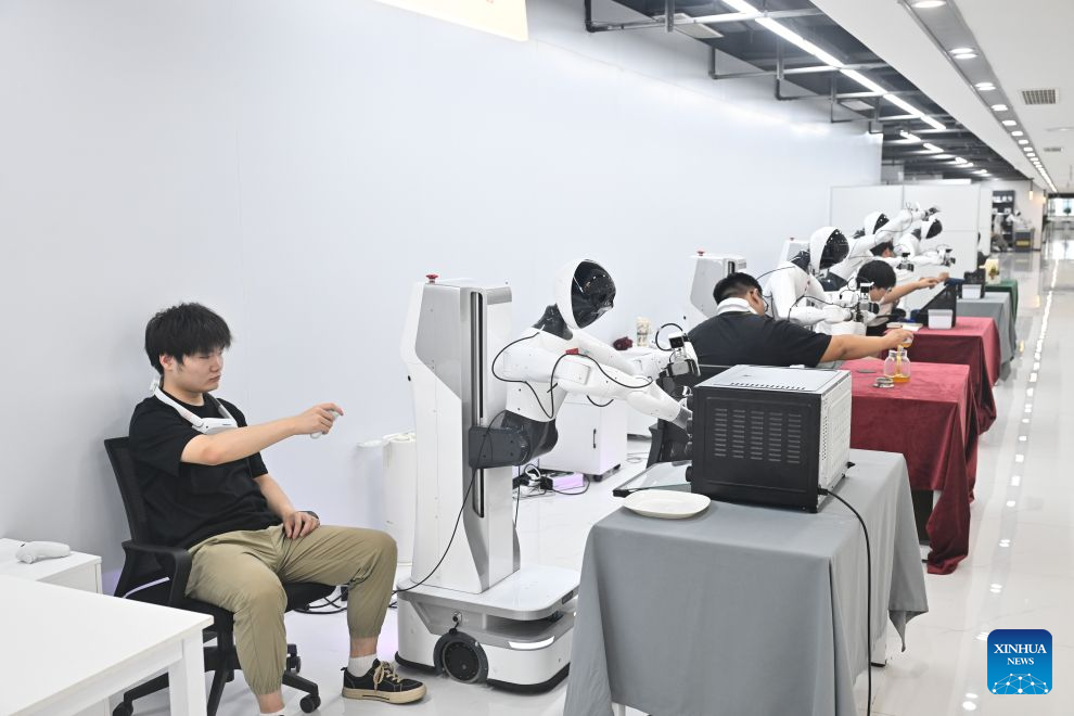 Technicians train robots at a robot data collection center of Chinese e-commerce giant JD.com in Suqian, east China's Jiangsu Province, Aug. 12, 2026. In operation since October 2025, JD.com's robot data collection center is a provincial-level embodied intelligent robot data collection center in east China's Jiangsu Province. The facility enhances the data collection scenarios in terms of physical fidelity, generalization ability, and interaction quality. It upgrades the data collection environment to a real physical scene, transforming the data collection center from a static sample library into a training ground for embodied intelligent robots. (Xinhua/Ji Chunpeng)