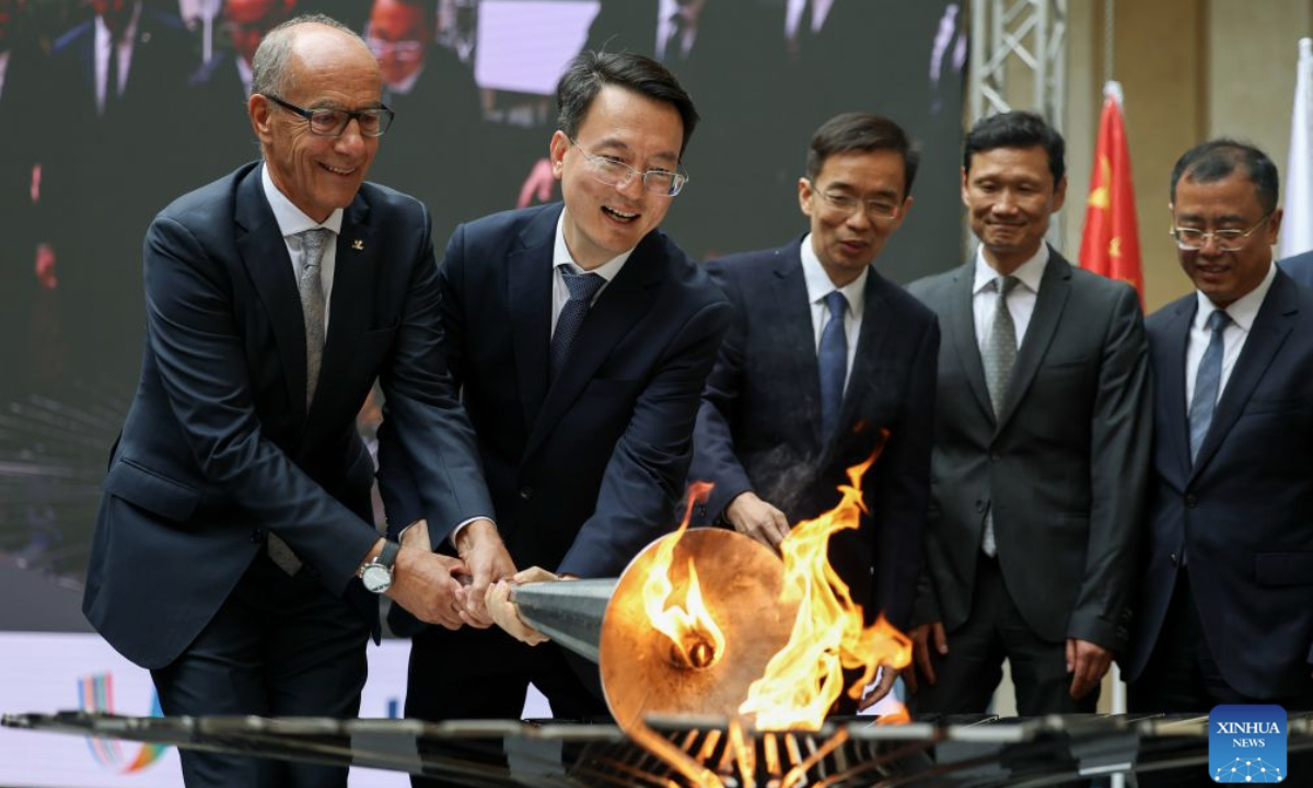 Mayor of Changchun Gu Gang (2nd L) and president of FISU Leonz Eder (1st L) jointly light the cauldron with the torch from the first World University Games in Turin in 1959 during the flame collection ceremony for the Changchun 2027 Winter Universiade in Turin, Italy, Oct. 8, 2026. (Xinhua/Wang Kaiyan)