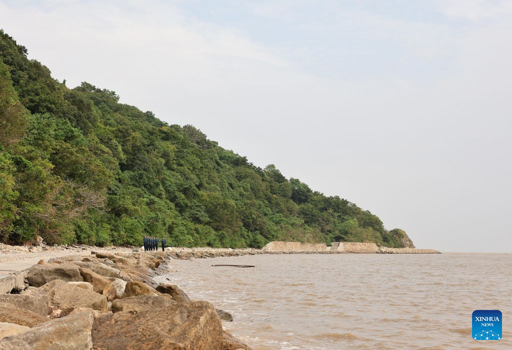 Law enforcers from China Coast Guard patrol on the Dajinshan island in Shanghai, east China, Sept. 18, 2026. Dajinshan island boasts an excellent natural environment. To better secure the biodiversity and the ecology on the island, members of the local coast guard regularly patrol here to check the growth of native vegetation, watch out for possible invasion of alien species, and monitor the water quality in the surrounding sea area. (Xinhua/Fang Zhe)