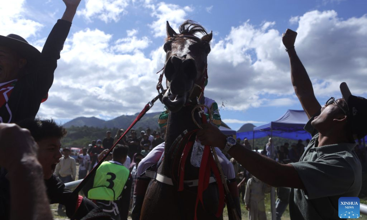 People celebrate after a jockey wins during a traditional horse race in Central Aceh Regency, Aceh Province, Indonesia, Aug. 30, 2026. (Photo by Fachrul Reza/Xinhua)