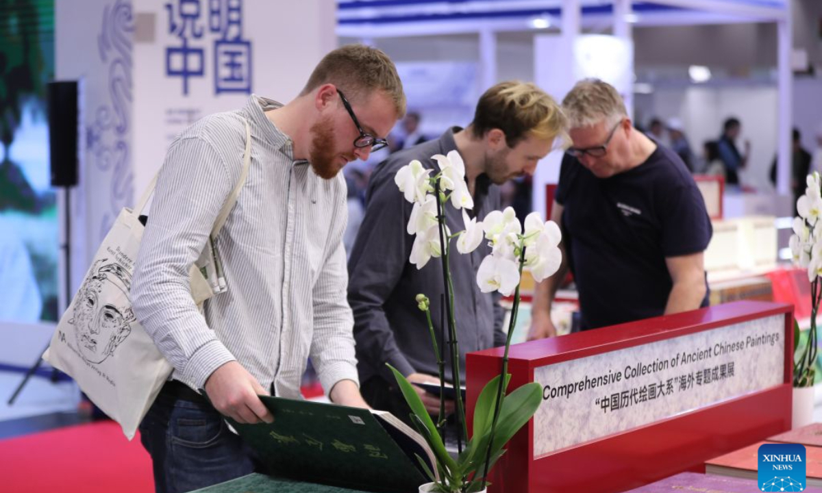 Visitors are seen at the Chinese joint exhibition booth of the Frankfurt Book Fair in Frankfurt, Germany, Oct. 7, 2026. The world's largest book fair opened Wednesday in Frankfurt, Germany, bringing together more than 4,000 publishing institutions from over 100 countries and regions. The Chinese joint exhibition booth covers 336 square meters and features more than 3,000 titles and over 4,600 copies of selected books. It combines book displays, rights negotiations, cultural exchanges and interactive experiences. (Xinhua/Du Zheyu)