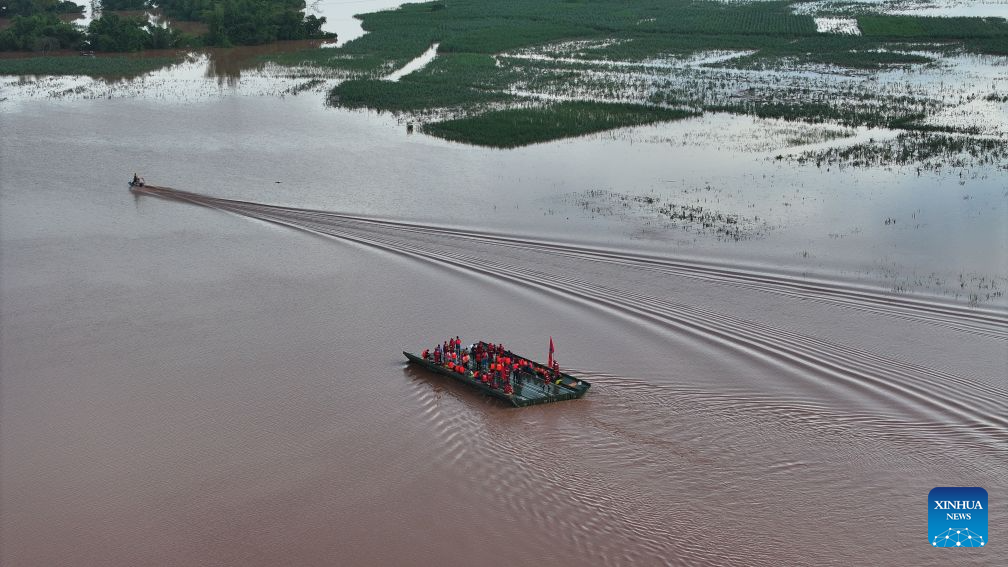 An aerial drone photo taken on Aug. 24, 2026 shows a powered pontoon bridge sailing in the flooded area in Beijiang Township, Ningming County, south China's Guangxi Zhuang Autonomous Region. Rescue forces have been deployed in Ningming County where typhoon-triggered heavy rainfall caused flood. A powered pontoon bridge was deployed for emergency rescue operations on Monday. (Xinhua/Zhou Hua)