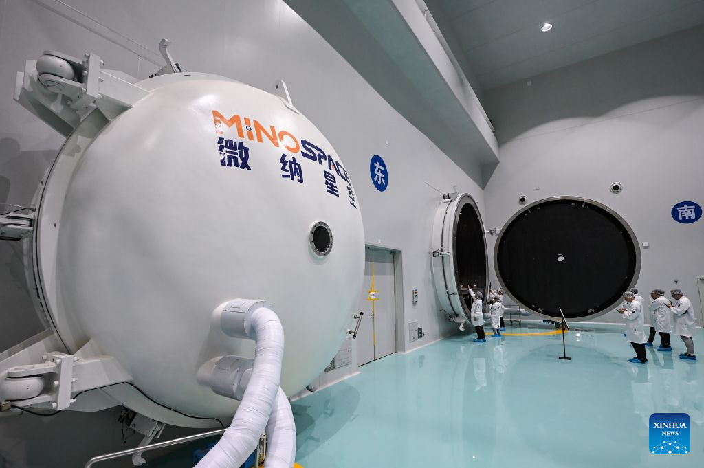 Journalists take photos of a thermal vacuum simulator at Guoyu Starry Sky Technology Co., Ltd. in the high-tech zone of Wuxi, east China's Jiangsu Province, July 20, 2026. Guoyu Starry Sky Technology Co., Ltd. specializes in the design and manufacturing of satellites. Its intelligent production line for commercial satellites can produce more than 150 units annually, each weighing between 200 kg and 500 kg. (Xinhua/Chen Yehua)