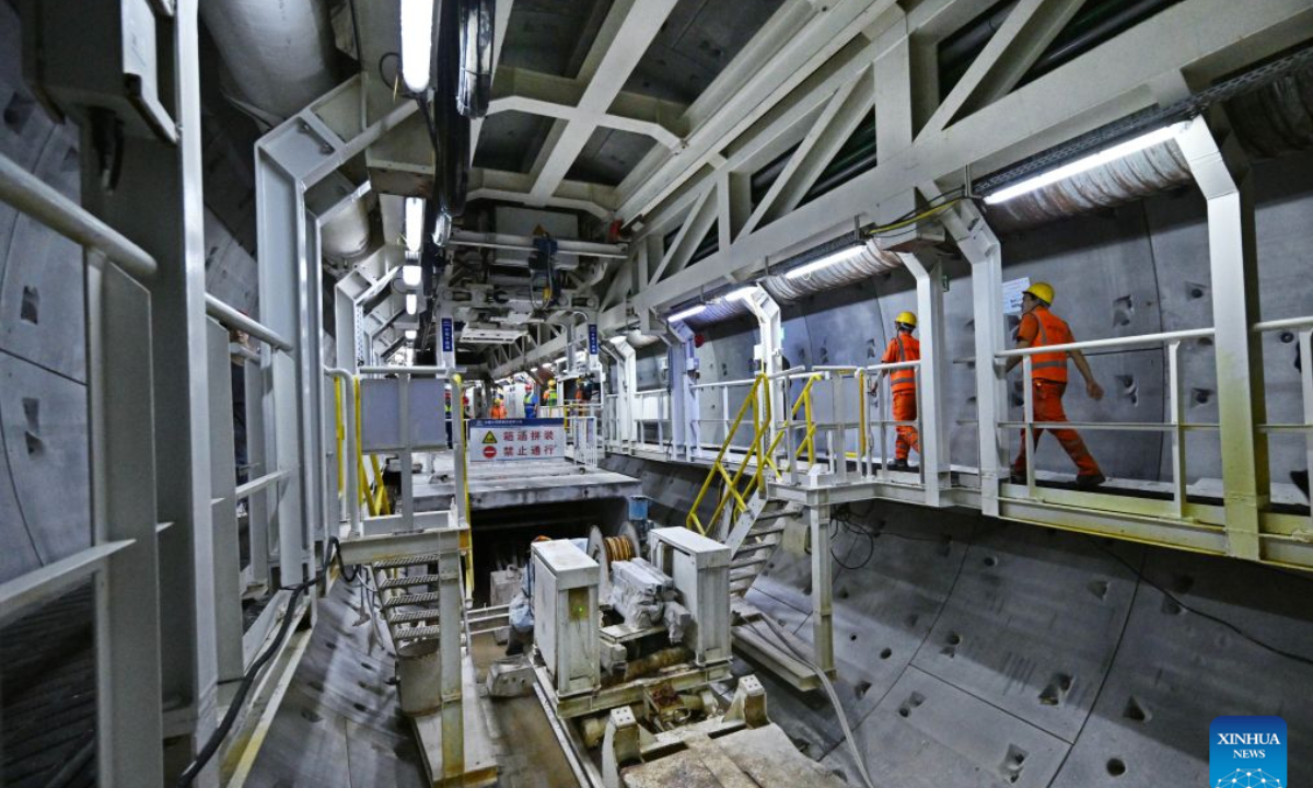 Constructors make a safety inspection at the construction site of Qingdao Jiaozhou Bay Second Tunnel in Qingdao, east China's Shandong Province, Oct. 2, 2026. China's longest undersea highway tunnel completed all shield-driven excavation work on Friday as a shield machine reached its designated position at a depth of 105 meters beneath the sea surface in Jiaozhou Bay, eastern China's Shandong Province, according to China Railway Construction Corporation Limited.
The Qingdao Jiaozhou Bay Second Tunnel will connect Qingdao's main urban area with the Qingdao West Coast New Area. The latter is a national-level new area. The 17.48-km project includes a 14.37-km main tunnel section, featuring two main tunnels and a middle service tunnel, with three lanes in each direction and a design speed of 80 km per hour. (Xinhua/Li Ziheng)