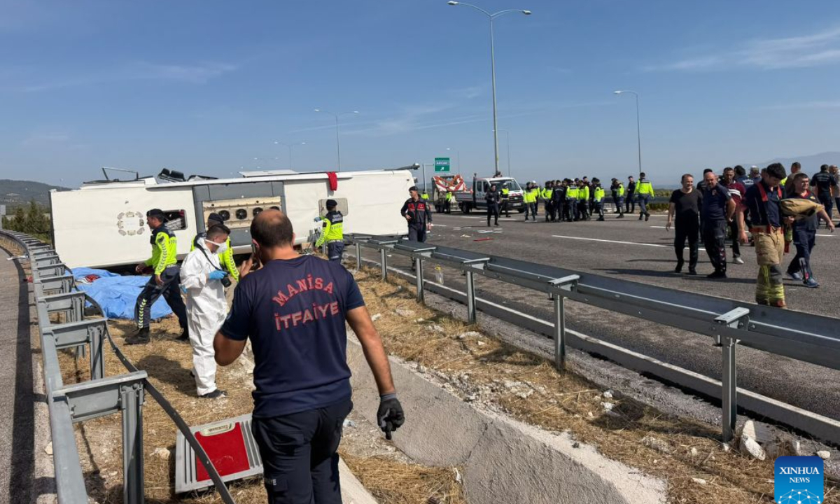 Workers are seen at the site of a traffic accident in the Akhisar district of Manisa, Türkiye, Oct. 11, 2026. At least 11 people were killed and 27 others injured on Sunday in a traffic accident involving a tour bus and a tow truck in Türkiye's western Manisa province, local authorities said. (Mustafa Kaya/Handout via Xinhua)