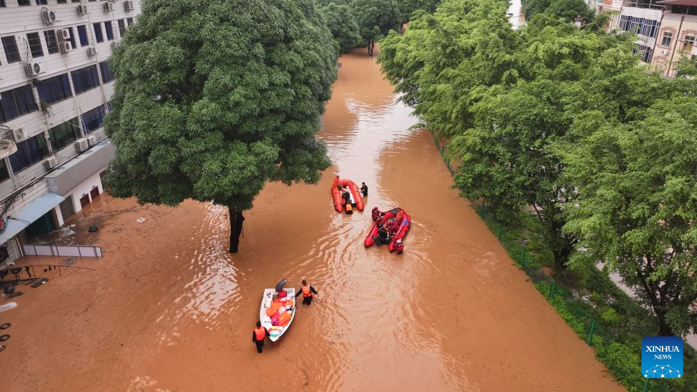 An aerial drone photo taken on Aug. 23, 2026 shows rescuers transferring stranded residents in Ningming County, south China's Guangxi Zhuang Autonomous Region. For days, Ningming County has been battered by typhoon-triggered heavy rainfall. Response forces have pooled their efforts to urgently evacuate stranded residents. (Xinhua/Zhou Hua)