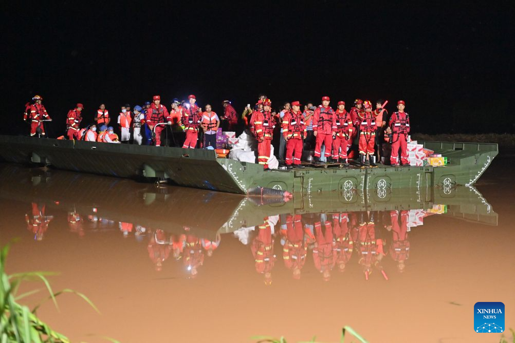 A powered pontoon bridge sails in the flooded area in Beijiang Township, Ningming County, south China's Guangxi Zhuang Autonomous Region, Aug. 24, 2026. Rescue forces have been deployed in Ningming County where typhoon-triggered heavy rainfall caused flood. A powered pontoon bridge was deployed for emergency rescue operations on Monday. (Xinhua/Zhou Hua)