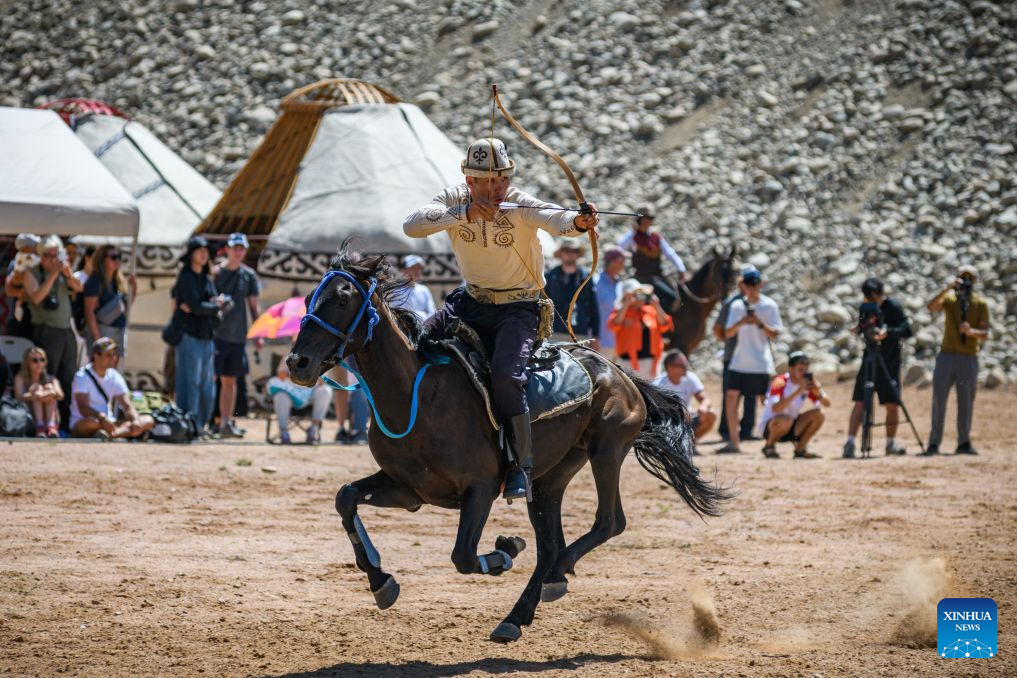A man is pictured during a horseback archery performance at a folk arts festival in the Bokonbaevo village at the south bank of the Issyk-Kul Lake, Kyrgyzstan, Aug. 1, 2026. (Xinhua)