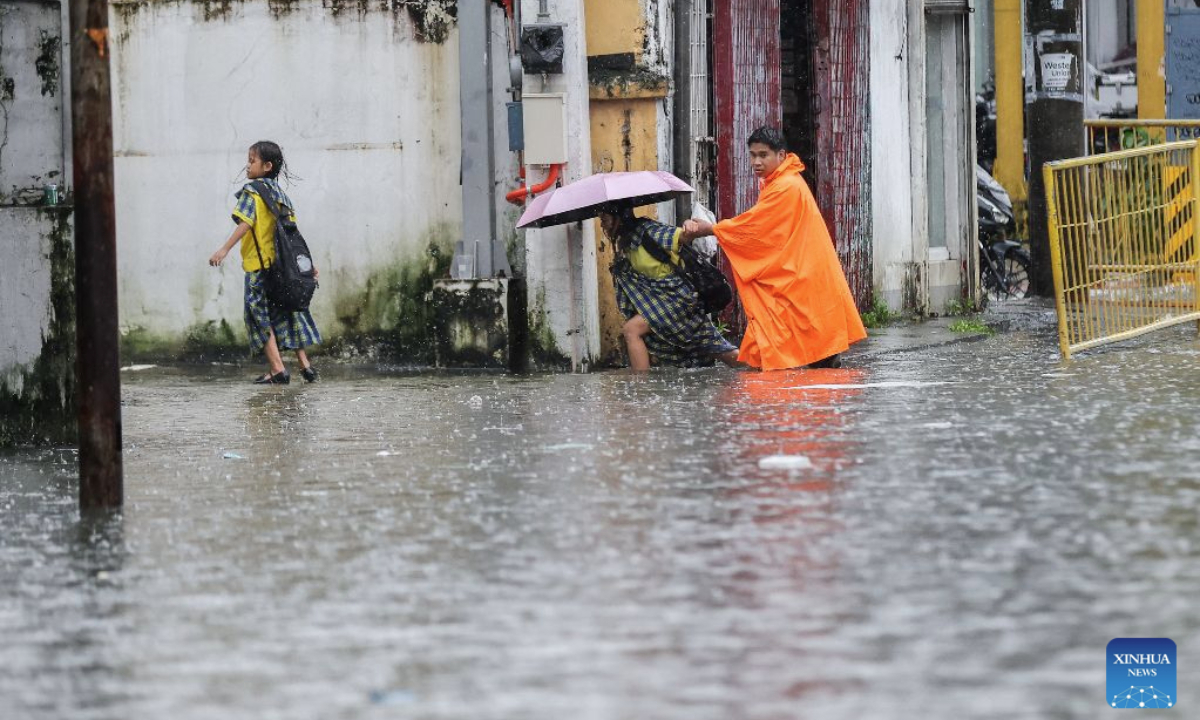 People wade through floodwater in Quezon City, the Philippines, on Aug. 17, 2026. The Philippine government has suspended in-person classes in Metro Manila and 12 other provinces as heavy rains from tropical cyclones and the southwest monsoon continue to batter the country, local media reported on Monday.
The extreme rainfall has triggered severe flooding and landslides across the nation. The well-known flood-control corruption scandal has left key infrastructure unfinished or poorly maintained, further straining the country's disaster response, local media reported. (Xinhua/Rouelle Umali)