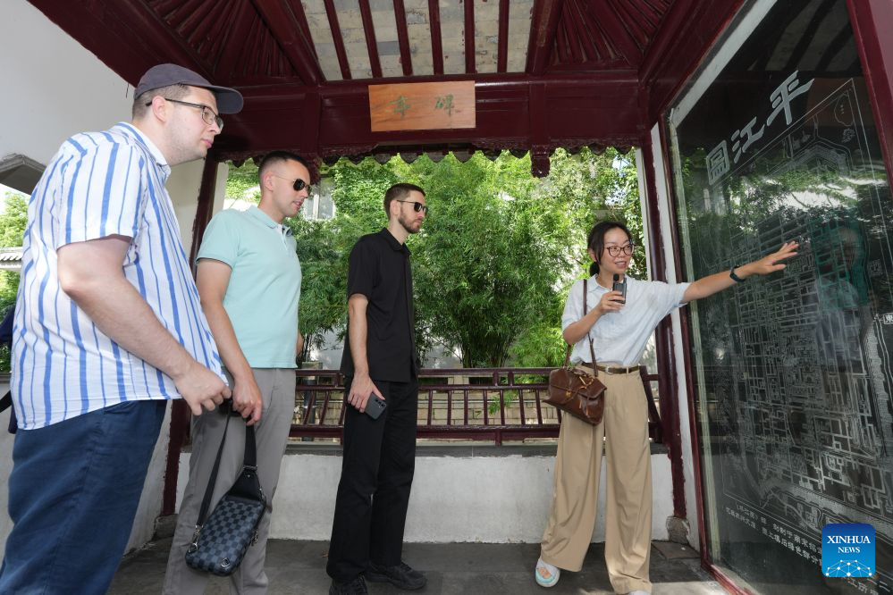 Members of a joint China-Russia media delegation visit Pingjiang Road, a block of historical and cultural interest, in Suzhou, east China's Jiangsu Province, Aug. 23, 2026. The delegation visited Suzhou from Aug. 22 to 23, experiencing the charm of China's Jiangnan culture. (Xinhua/Li Bo)