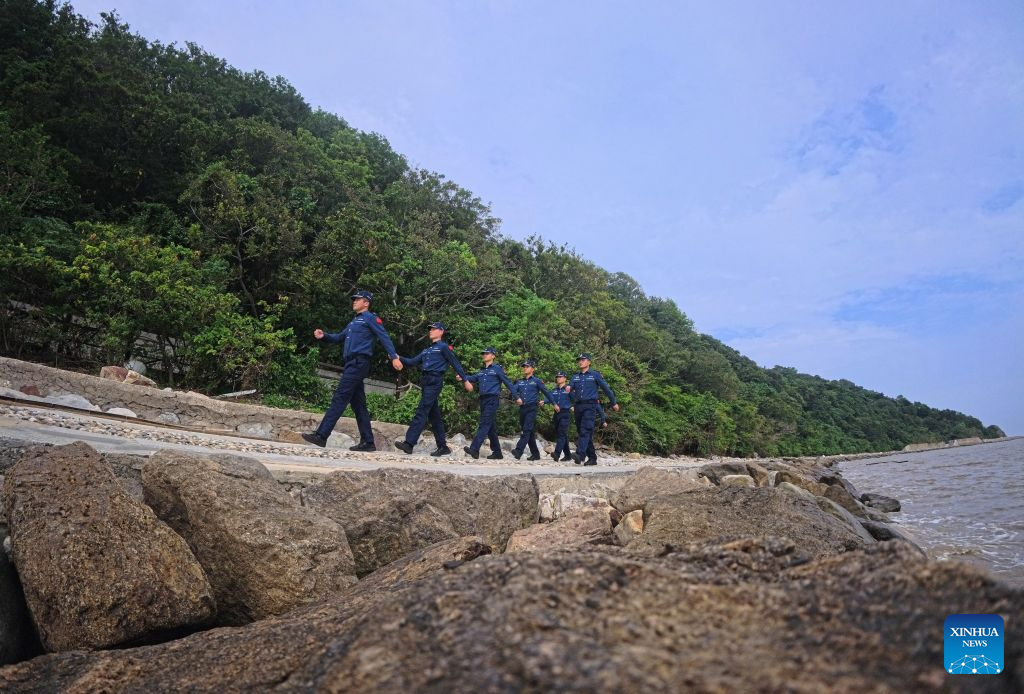 Law enforcers from China Coast Guard patrol on the Dajinshan island in Shanghai, east China, Sept. 18, 2026. Dajinshan island boasts an excellent natural environment. To better secure the biodiversity and the ecology on the island, members of the local coast guard regularly patrol here to check the growth of native vegetation, watch out for possible invasion of alien species, and monitor the water quality in the surrounding sea area. (Xinhua/Fang Zhe)