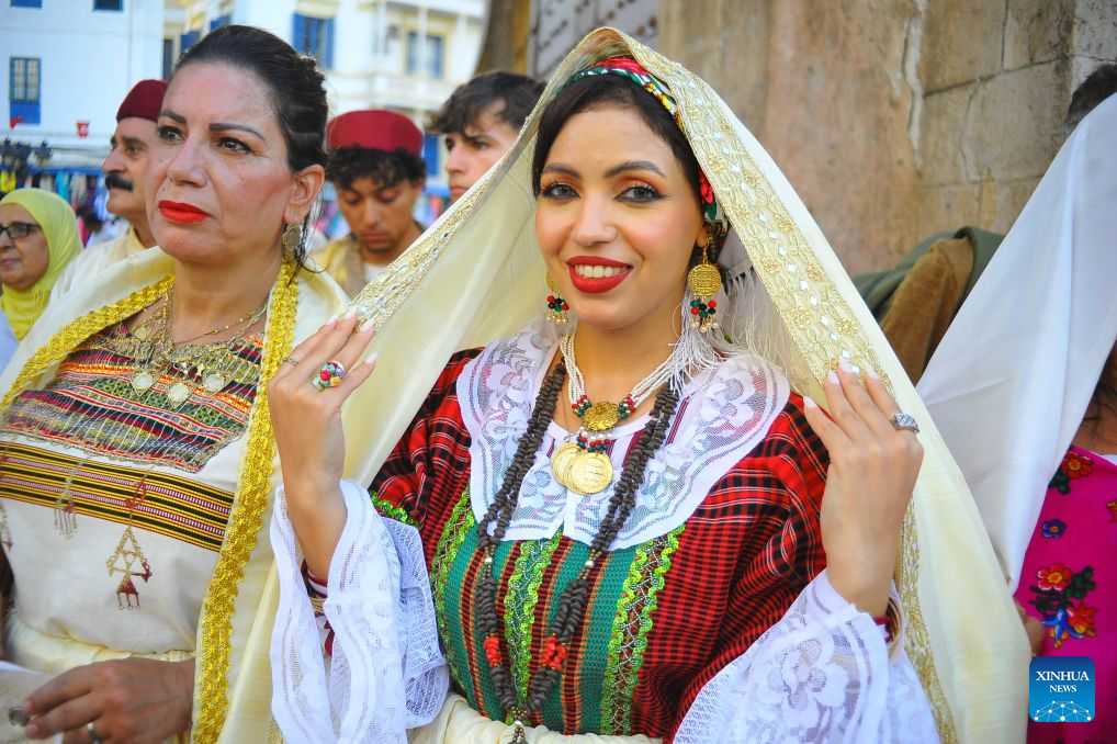 A Tunisian woman in traditional costumes is pictured during the celebration of the annual National Women's Day in Tunis, Tunisia, Aug. 13, 2026. (Photo by Adel Ezzine/Xinhua)