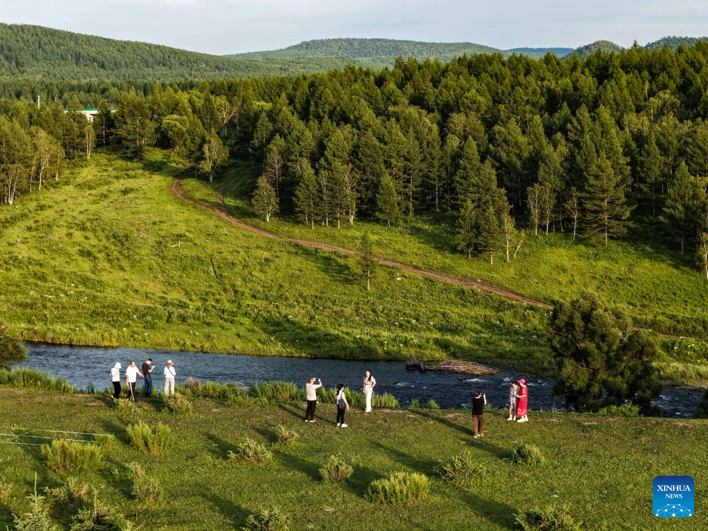 An aerial drone photo taken on July 28, 2026 shows people visiting the Arxan National Forest Park in Arxan of Hinggan League, north China's Inner Mongolia Autonomous Region. (Xinhua/Li Zhipeng)
