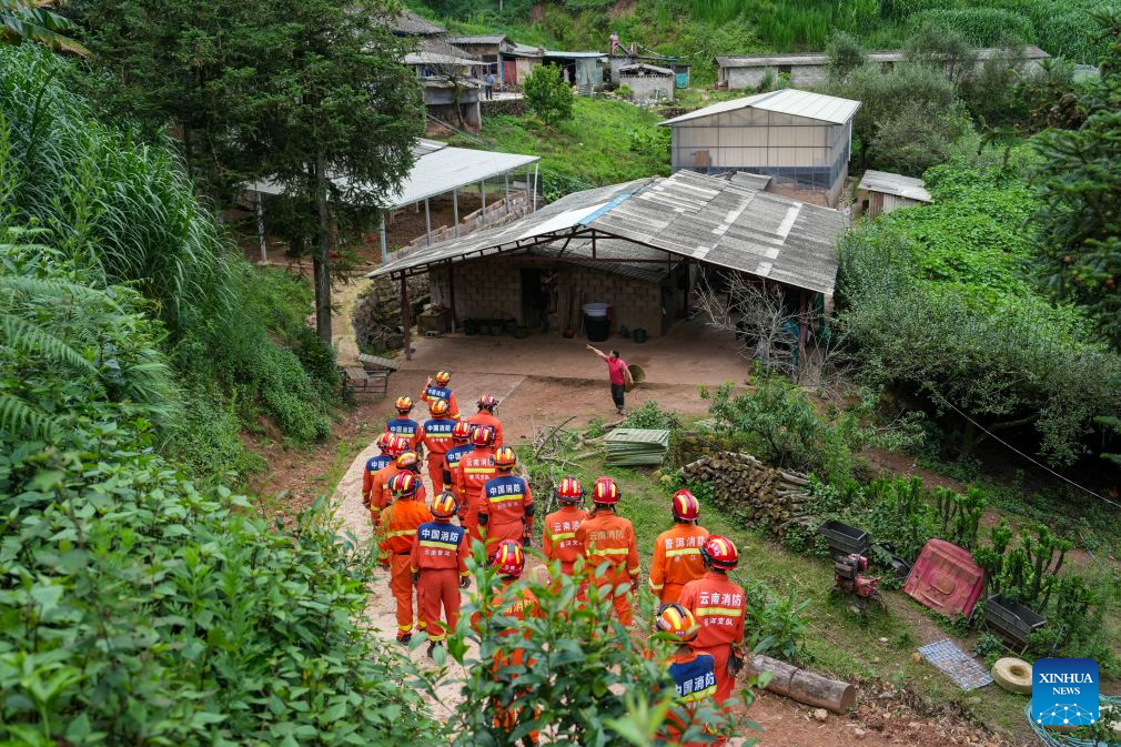 Firefighters walk to check affected houses at Jingping Village in Yutang Town of Mojiang Hani Autonomous County, southwest China's Yunnan Province, on July 22, 2026. The Yunnan provincial earthquake relief headquarters has activated a Level-IV emergency response after a 5.0-magnitude earthquake jolted Mojiang on Tuesday, local authorities said. No casualties have been reported so far. (Xinhua/Chen Xinbo)