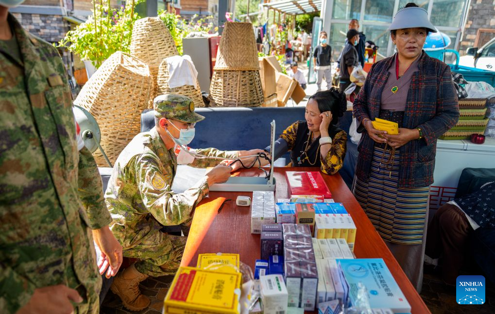 A military health worker measures blood pressure for a local at a village in Gyirong Town, southwest China's Xizang Autonomous Region, Sept. 1, 2026. Health workers from the Xizang military authority carried out on-site medical rounds and disinfection on Tuesday to ensure fundamental medical needs of the rescuers and the locals. (Xinhua/Tenzin Nyida)
