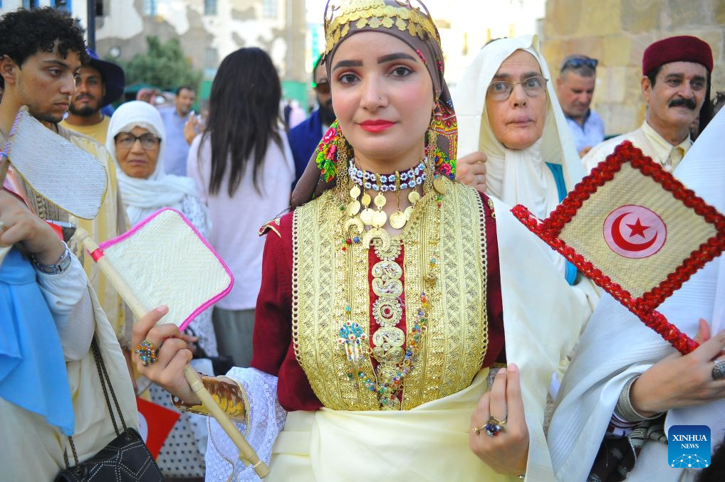 A Tunisian woman in traditional costumes is pictured during the celebration of the annual National Women's Day in Tunis, Tunisia, Aug. 13, 2026. (Photo by Adel Ezzine/Xinhua)