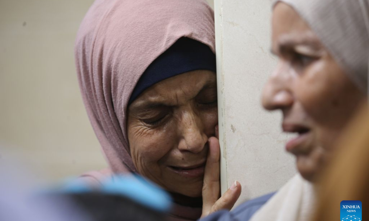 Relatives mourn during the funeral of Palestinian child Islam Ahmad Ajjouri, in Askar Al-Jadid refugee camp, east of Nablus, in the West Bank, Aug. 23, 2026. The Palestinian child Islam Ahmad Ajjouri, 14, was killed on Sunday afternoon after succumbing to a critical gunshot wound sustained earlier in the day during an Israeli military raid on Askar Al-Jadid refugee camp. (Photo by Nidal Eshtayeh/Xinhua)