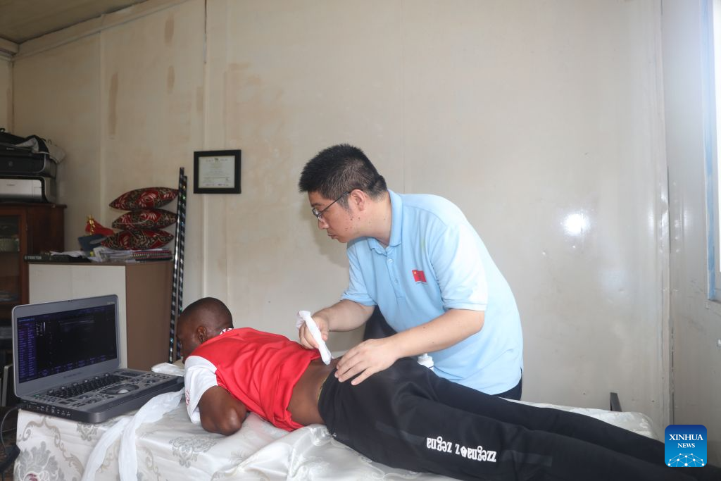 This file photo taken on Oct. 8, 2025 shows Yuan Gang, a radiologist with the 35th Chinese medical team in Zanzibar, performing an ultrasound examination on a patient at a local health facility during a community health outreach activity in Zanzibar, Tanzania. (The 35th Chinese medical team in Zanzibar/Handout via Xinhua)
