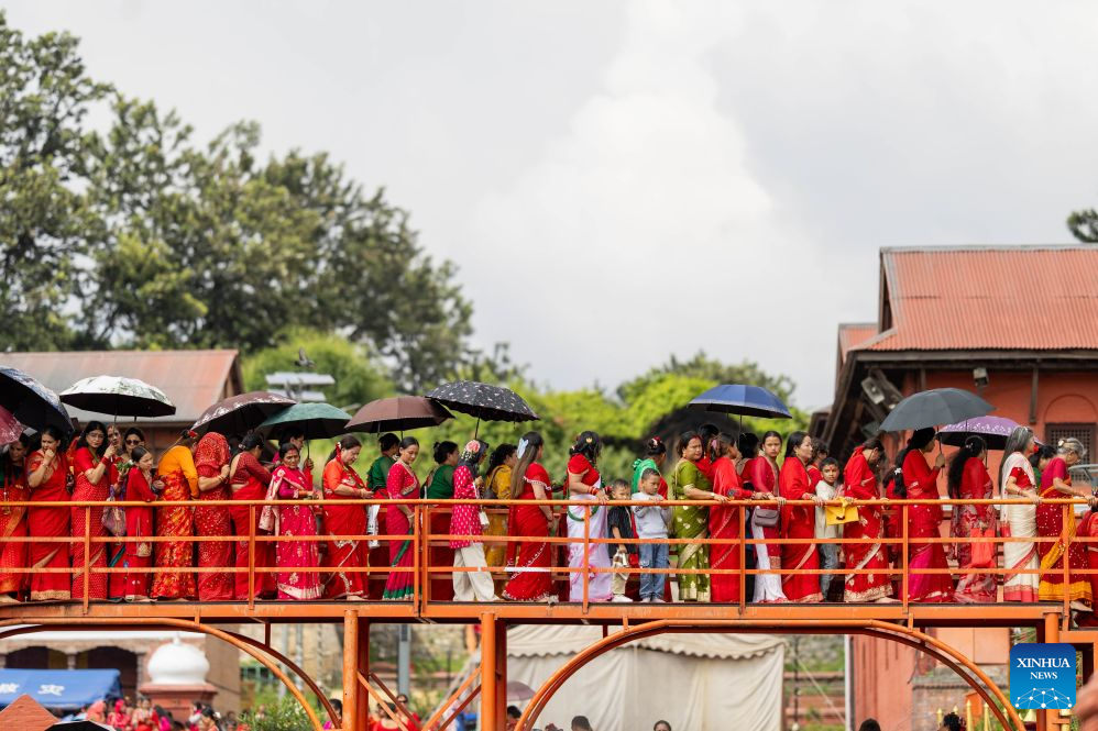People queue to worship at the Pashupatinath Temple during the Teej Festival in Kathmandu, Nepal, Sept. 14, 2026. Hindu women observe the festival by fasting, praying and celebrating, seeking marital well-being and ideal partners. (Photo by Sulav Shrestha/Xinhua)
