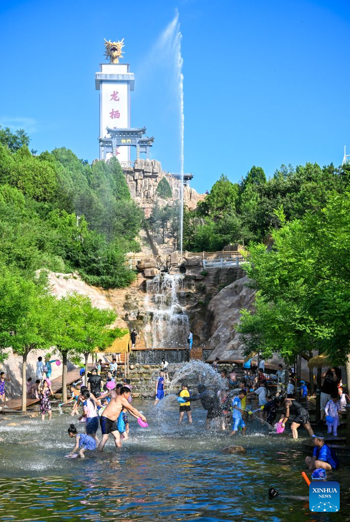 Tourists play at a water park in Tianjin, north China, Aug. 4, 2026. (Xinhua/Sun Fanyue)