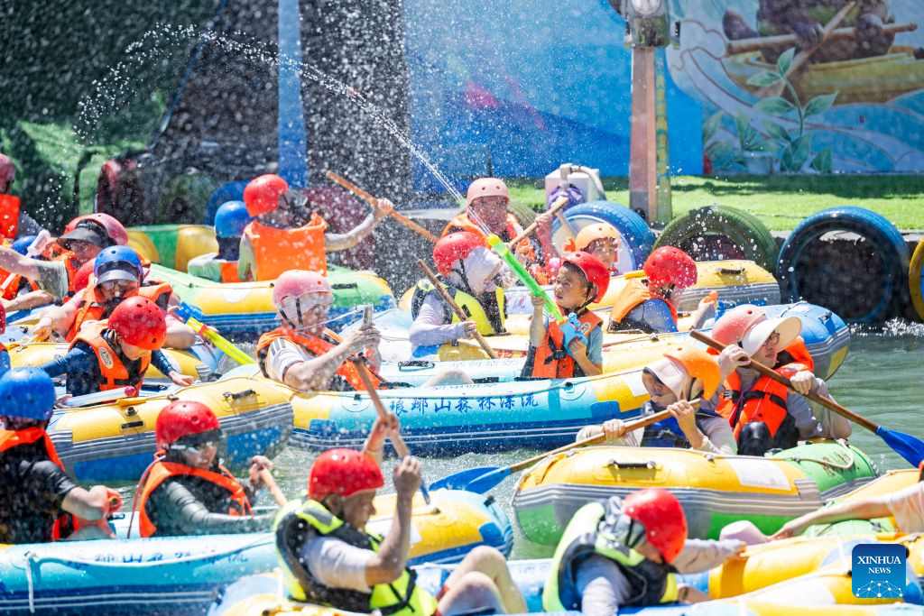 Tourists enjoy drifting at the Langya Mountain scenic area in Chuzhou, east China's Anhui Province, on Aug. 2, 2026. Located in the southwest of Chuzhou, the Langya Mountain scenic area is home to the renowned Zuiweng Pavilion, which was featured in a celebrated essay by Northern Song Dynasty literary figure Ouyang Xiu. In summer, the scenic area attracts visitors with daytime sightseeing and nighttime markets. (Photo by Ji Chengjun/Xinhua)