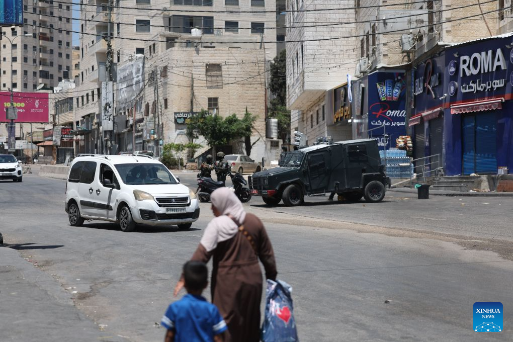 Israeli security personnel stand guard near the Qalandiya checkpoint, north of Jerusalem, Aug. 6, 2026. Israeli military and police forces have intensified security operations in and around Jerusalem, as persistent violence across the West Bank drives up regional tensions recently. (Photo by Jamal Awad/Xinhua)