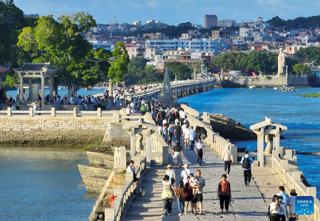 An aerial drone photo taken on Aug. 18, 2026 shows tourists visiting Luoyang Bridge in Quanzhou, southeast China's Fujian Province. Luoyang Bridge, also known as Wan'an Bridge, is a component of the UNESCO World Heritage site Quanzhou: Emporium of the World in Song-Yuan China.
In recent years, Quanzhou has woven cultural heritage into daily life by introducing intangible cultural heritage programs and cultural and creative businesses, attracting more tourists to the area. (Xinhua/Lin Shanchuan)