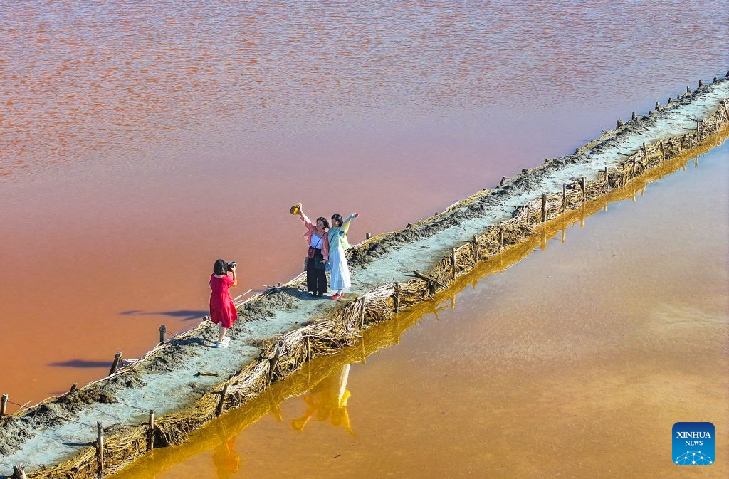 An aerial drone photo taken on Aug. 5, 2026 shows tourists posing for photos at a salt lake in Otog Front Banner in the city of Ordos, north China's Inner Mongolia Autonomous Region. (Photo by Wang Zheng/Xinhua)