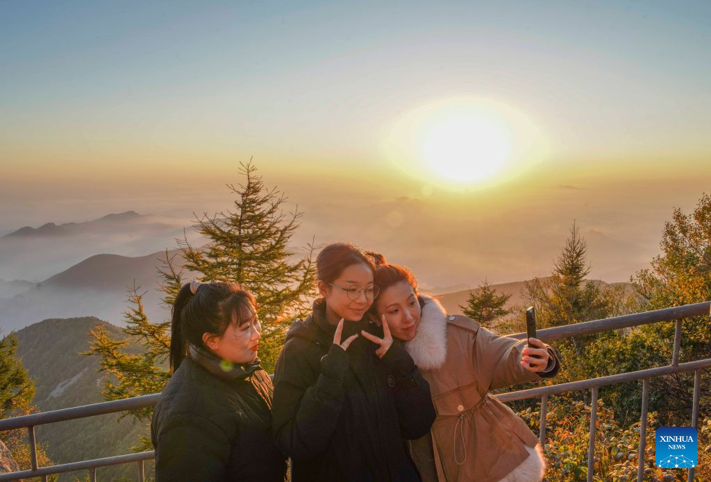 Tourists pose for selfies at Wuling Mountain National Nature Reserve in Xinglong County of Chengde City, north China's Hebei Province, Sept. 16, 2026. (Photo by Liu Mancang/Xinhua)