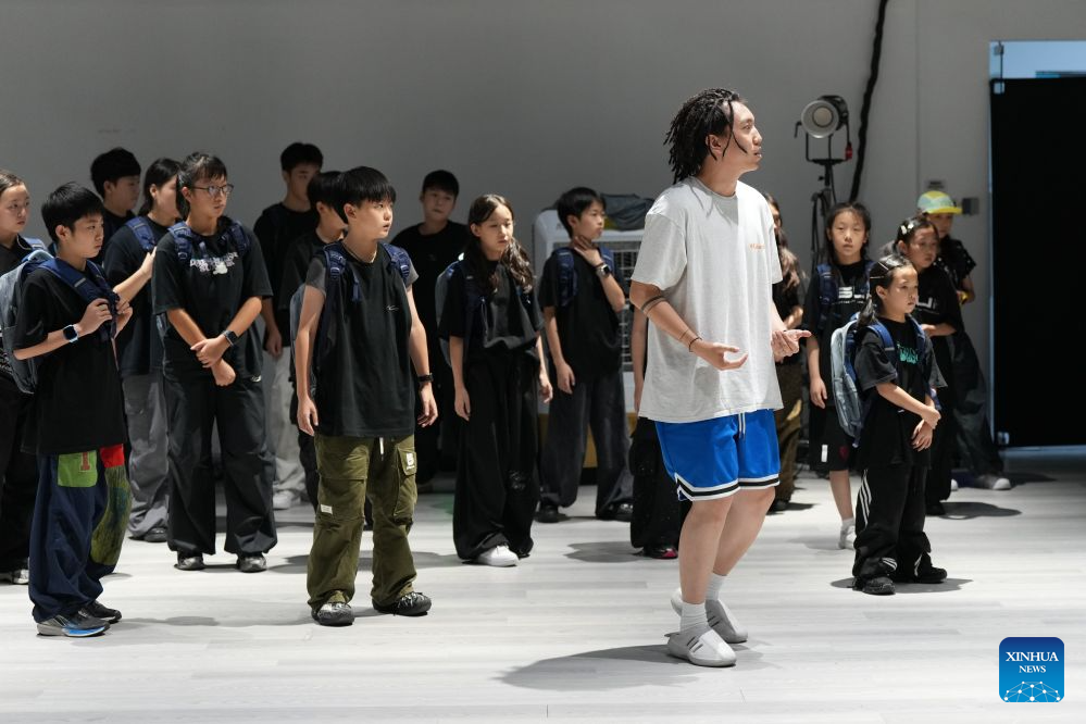 Fang Zhenghua (front) leads dancers during a rehearsal at Dancehome studio in Chengdu, southwest China's Sichuan Province, Aug. 1, 2026. (Xinhua/Xu Bingjie)
