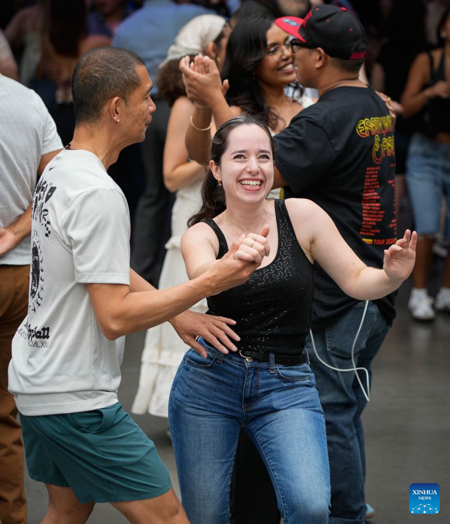 People participate in the Sunday Afternoon Salsa and Bachata event at Robson Square in Vancouver, British Columbia, Canada, on Aug. 30, 2026. Hundreds of people of different ages took part in the annual Sunday Afternoon Salsa and Bachata event here on Sunday. The outdoor event brought together dance enthusiasts and beginners to enjoy Latin-style music and dancing. (Photo by Liang Sen/Xinhua)