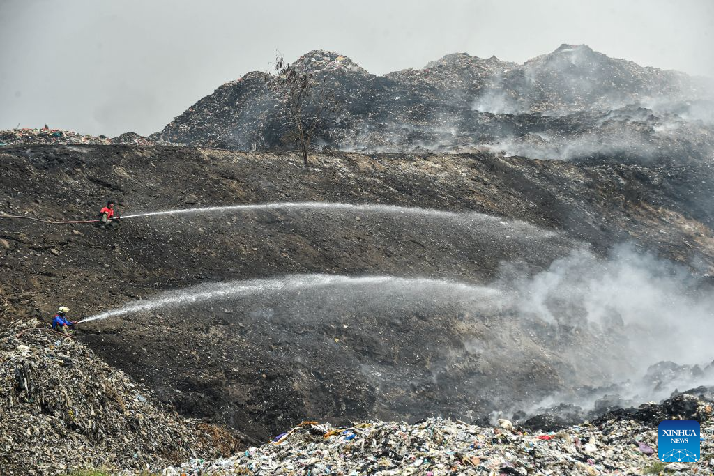 Firefighters attempt to put out a fire at the smoldering landfill in Tangerang Regency, Banten Province, Indonesia, on July 2, 2026. A fire broke out at a landfill in Tangerang regency, near the Indonesian capital city of Jakarta, on Tuesday, scorching more than two hectares of land, local officials said. (Xinhua/Agung Kuncahya B.)