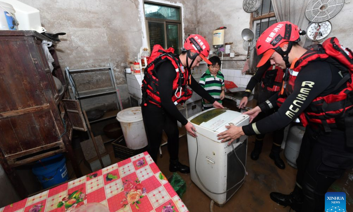 Rescuers help a resident transfer a washing machine in Nanqian Village of Minhou County, southeast China's Fujian Province, Sept. 3, 2026. Typhoon Saudel brought torrential rains to Minhou County of Fujian Province, resulting in waterlogging in some areas. Emergency flood-control, drainage and resident-evacuation operations were conducted to safeguard public safety. (Xinhua/Jiang Kehong)