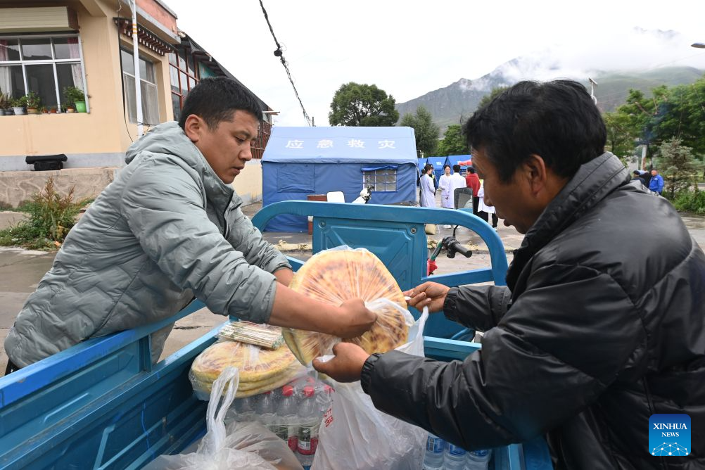 Villagers prepare lunch for rescuers at a temporary relocation site in Madang Town, Xiahe County of the Tibetan Autonomous Prefecture of Gannan, northwest China's Gansu Province, July 16, 2026. Severe convective weather triggered mountain torrents here from July 13 to 14. Two temporary relocation sites were set up in Madang Town to accommodate 107 affected residents. (Xinhua/Fan Peishen)