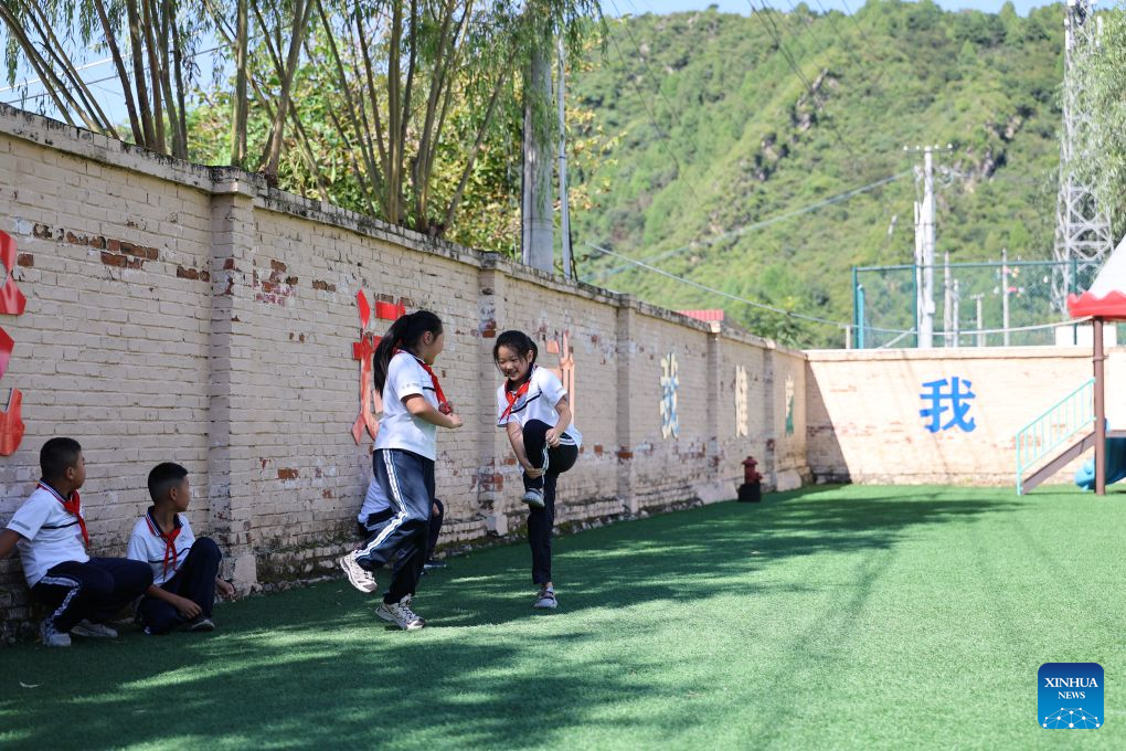 Students take a break on the playground at Hongshuizhuang central primary school Sangyuan branch in Luozhuangzi Town of Tianjin, north China, Sept. 1, 2026. The school, located at the foot of the Yanshan Mountains, has only 28 students from three surrounding villages of Sangyuan, Nihe and Shangbaiyu, and is the primary school with the fewest students in Jizhou District. On the first day of school, it held a flag-raising ceremony and gave the students the first lessons of the new term. (Xinhua/Li Ran)