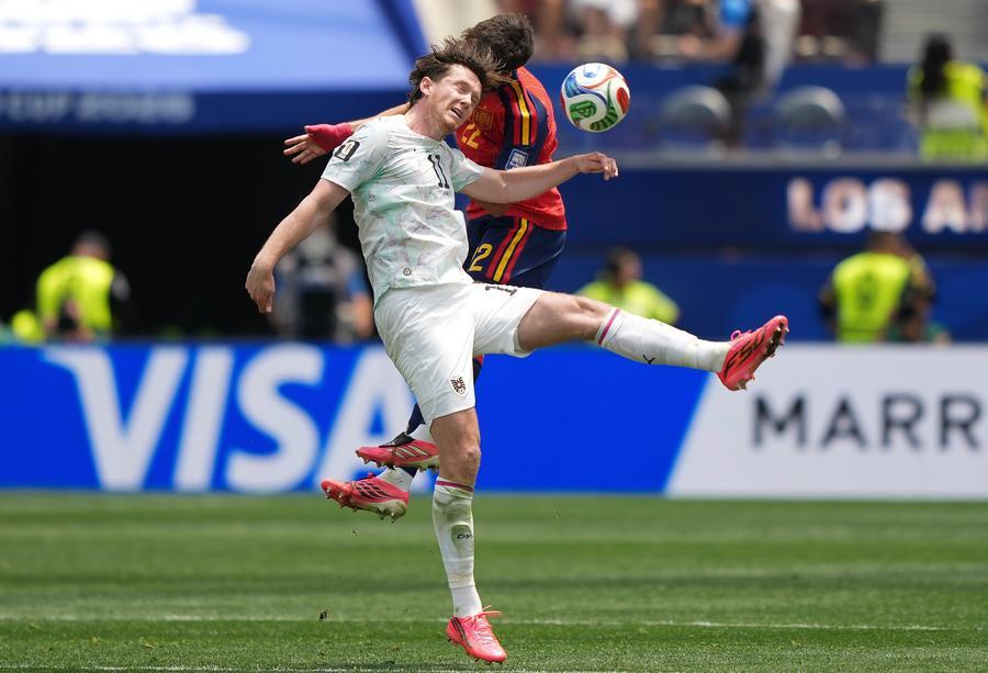 Austria's Michael Gregoritsch (front) vies with Spain's Alexander Prass for a header during the match. (Xinhua/Chen Yichen)